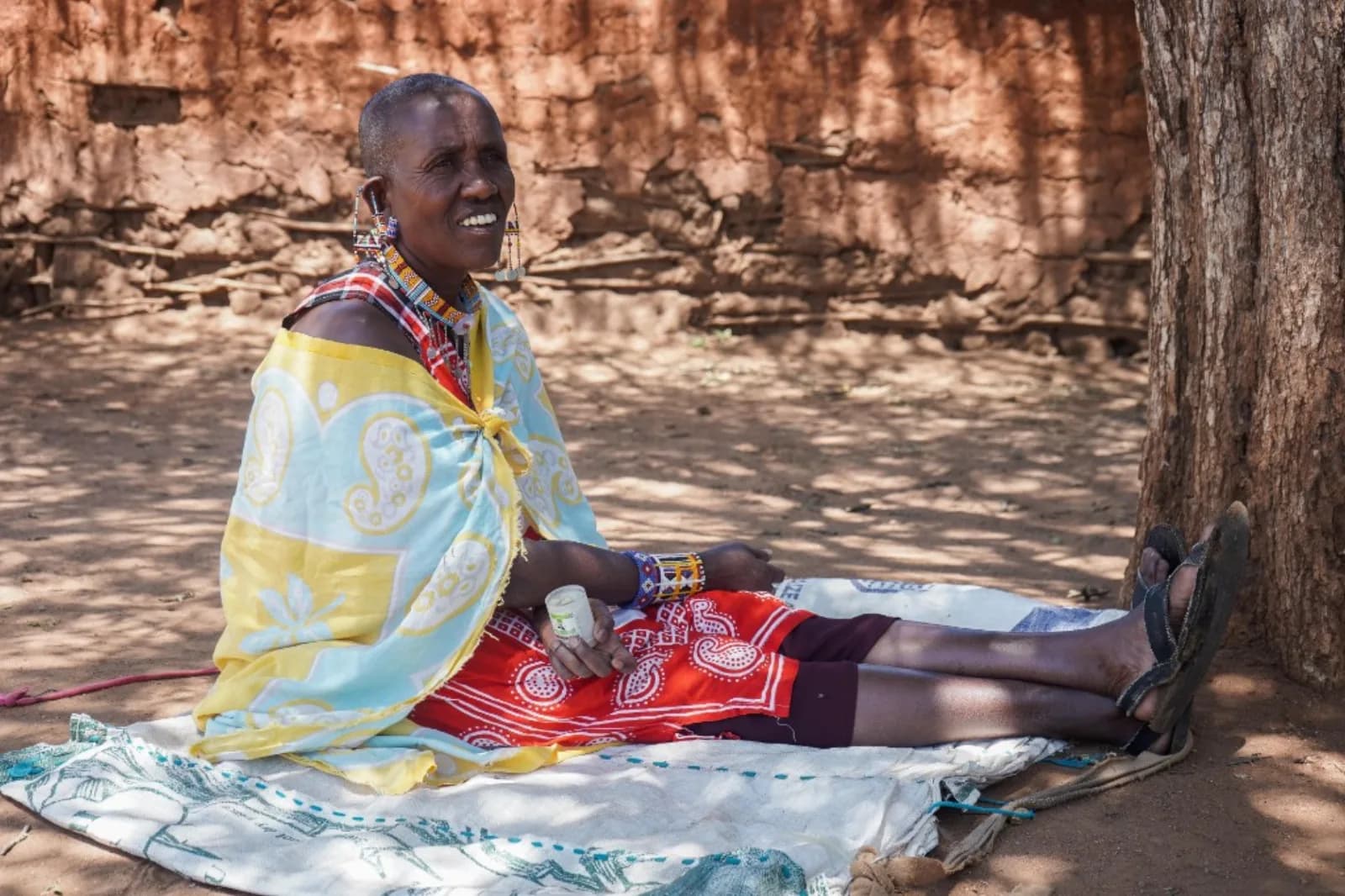 A woman resting in her homestead during a community session.