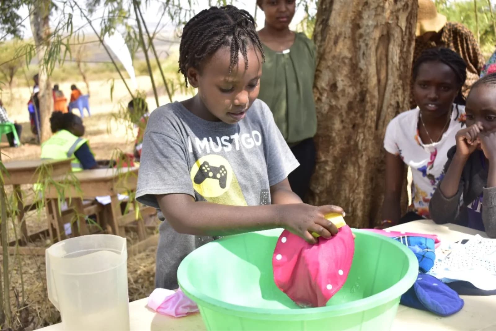 A girl taking part in a hands-on community menstrual health session.